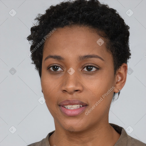 Joyful black young-adult female with short  brown hair and brown eyes