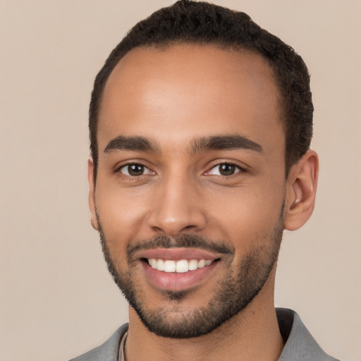 Joyful white young-adult male with short  black hair and brown eyes