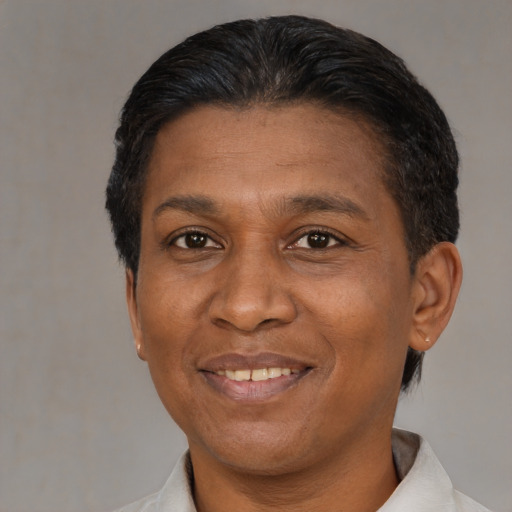 Joyful black adult female with short  black hair and brown eyes