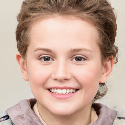 Joyful white child female with short  brown hair and grey eyes