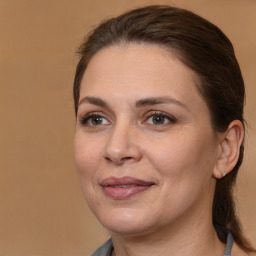 Joyful white adult female with medium  brown hair and brown eyes