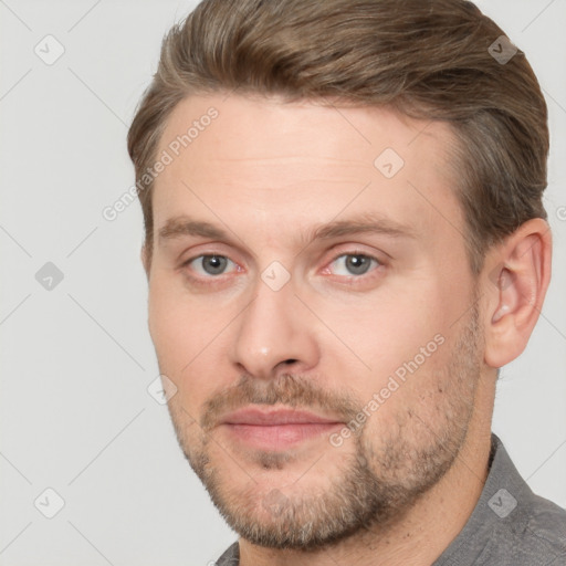 Joyful white adult male with short  brown hair and brown eyes