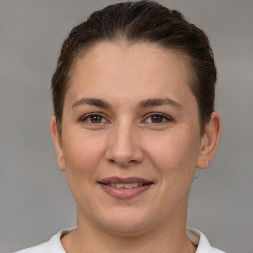 Joyful white adult female with short  brown hair and brown eyes