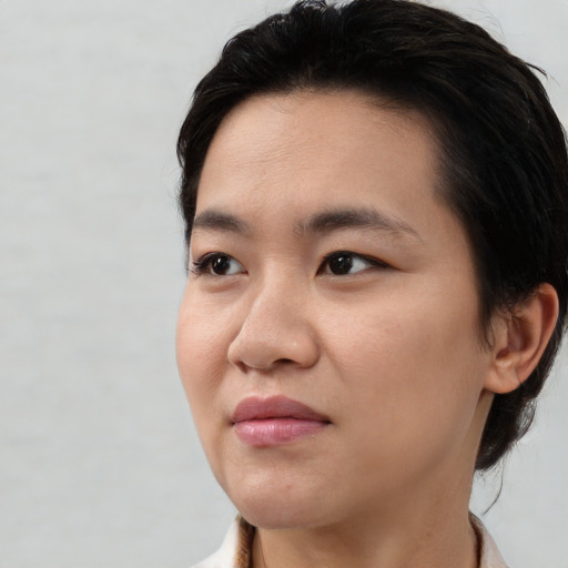 Joyful white young-adult female with short  black hair and brown eyes