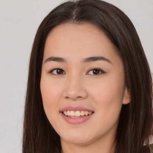Joyful asian young-adult female with long  brown hair and brown eyes