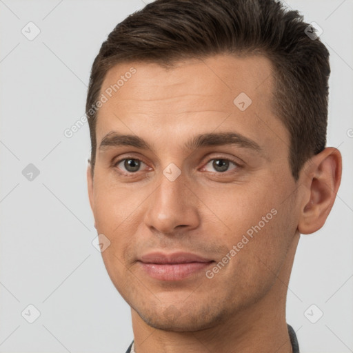 Joyful white young-adult male with short  brown hair and brown eyes