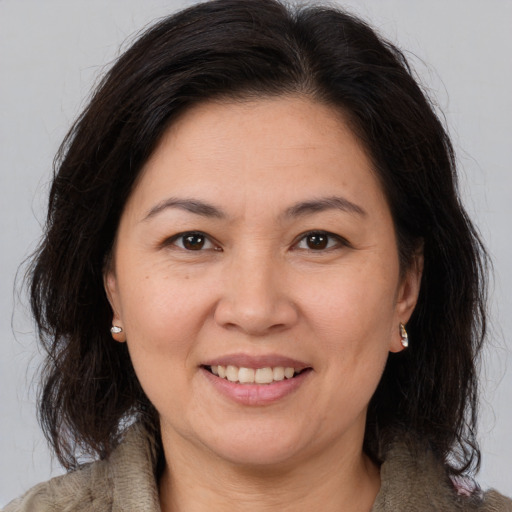 Joyful white adult female with medium  brown hair and brown eyes