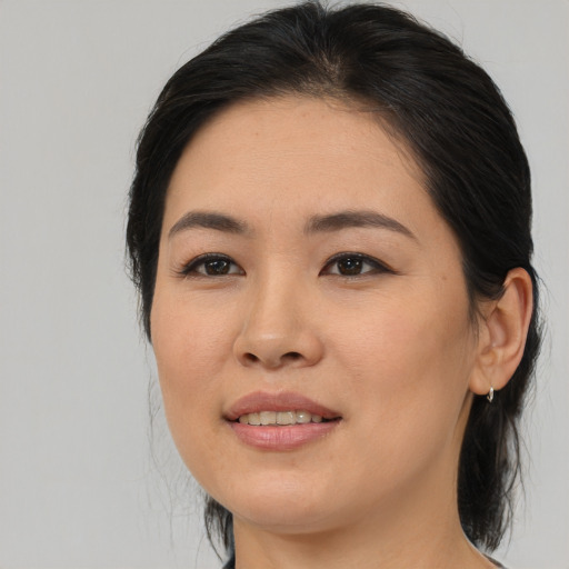 Joyful asian young-adult female with medium  brown hair and brown eyes