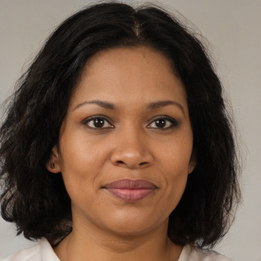 Joyful black young-adult female with medium  brown hair and brown eyes