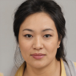 Joyful asian young-adult female with medium  brown hair and brown eyes