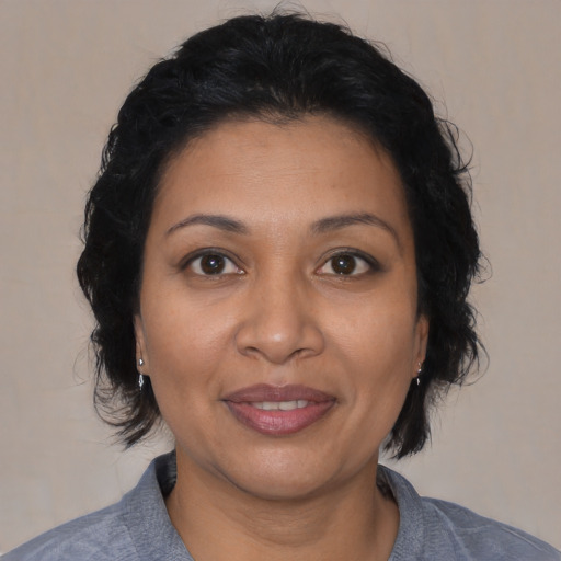 Joyful latino young-adult female with medium  black hair and brown eyes
