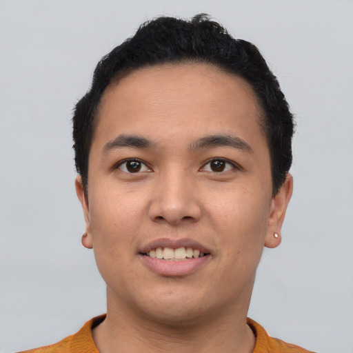 Joyful asian young-adult male with short  black hair and brown eyes