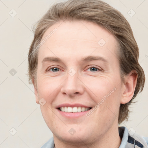 Joyful white young-adult female with medium  brown hair and blue eyes