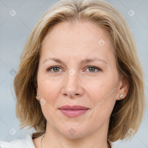 Joyful white adult female with medium  brown hair and grey eyes