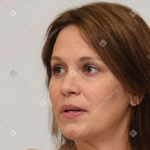 Joyful white adult female with medium  brown hair and brown eyes