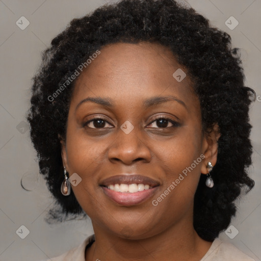 Joyful black young-adult female with long  brown hair and brown eyes