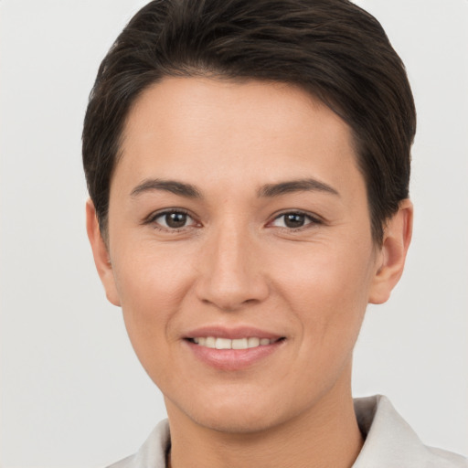 Joyful white young-adult female with short  brown hair and brown eyes