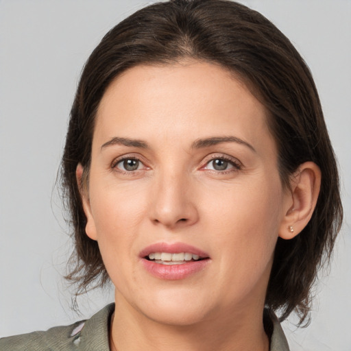 Joyful white young-adult female with medium  brown hair and brown eyes