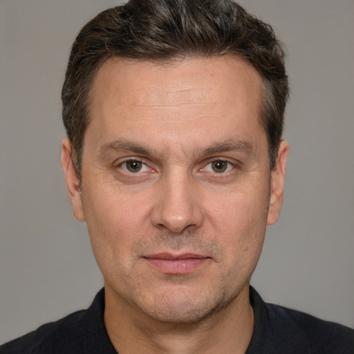 Joyful white adult male with short  brown hair and brown eyes