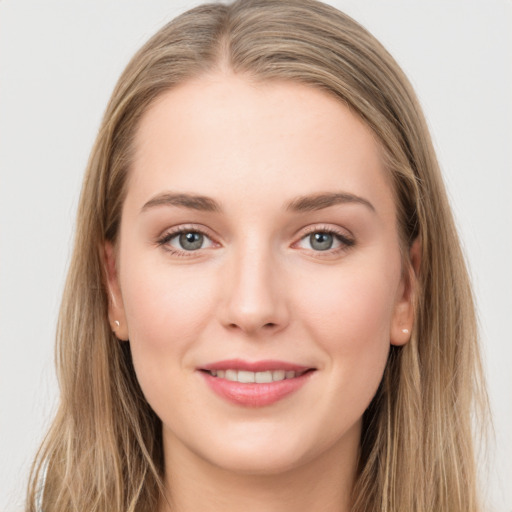 Joyful white young-adult female with long  brown hair and grey eyes