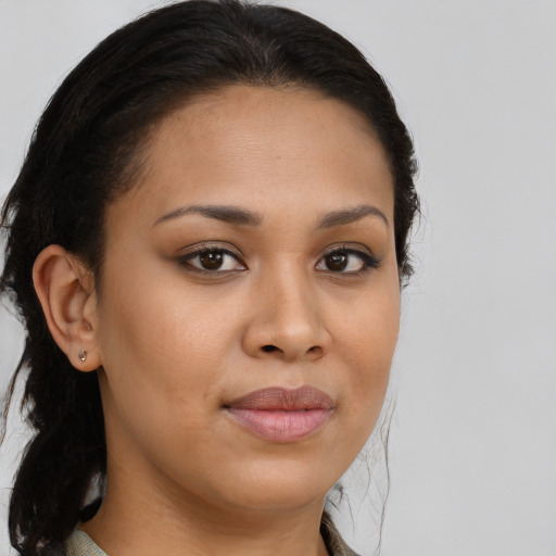 Joyful black young-adult female with long  brown hair and brown eyes