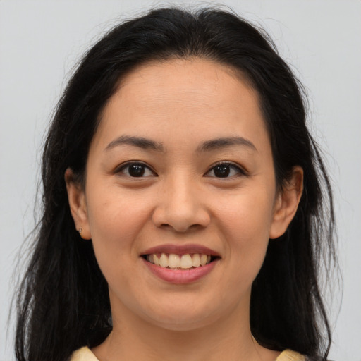 Joyful asian young-adult female with long  brown hair and brown eyes