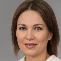 Joyful white adult female with medium  brown hair and brown eyes