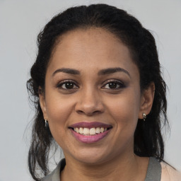 Joyful latino young-adult female with medium  brown hair and brown eyes