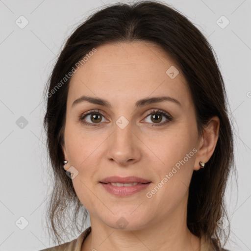 Joyful white young-adult female with long  brown hair and brown eyes