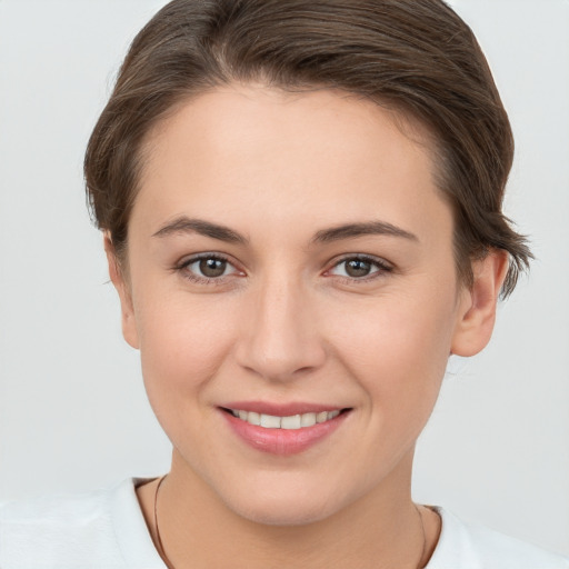 Joyful white young-adult female with short  brown hair and brown eyes