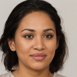 Joyful latino young-adult female with medium  brown hair and brown eyes