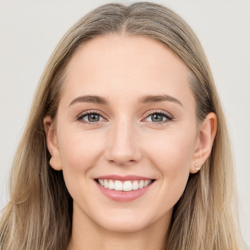 Joyful white young-adult female with long  brown hair and grey eyes