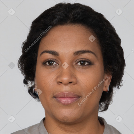 Joyful black adult female with short  black hair and brown eyes