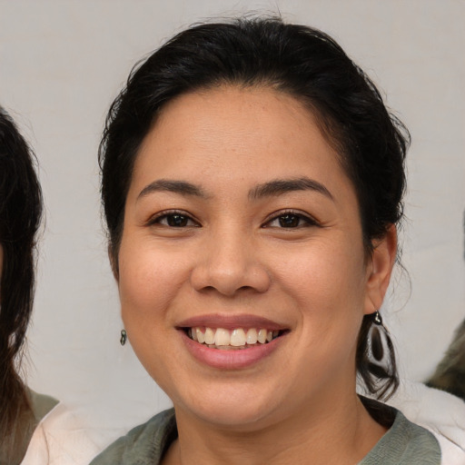 Joyful asian young-adult female with medium  brown hair and brown eyes