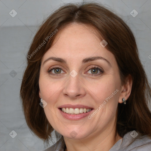 Joyful white adult female with medium  brown hair and grey eyes