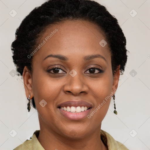 Joyful black young-adult female with long  brown hair and brown eyes