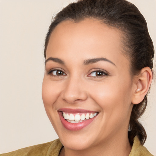 Joyful white young-adult female with long  brown hair and brown eyes