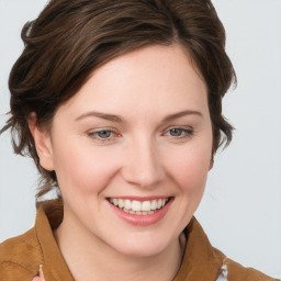 Joyful white young-adult female with medium  brown hair and blue eyes