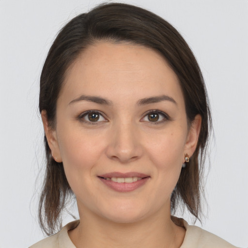 Joyful white young-adult female with medium  brown hair and brown eyes