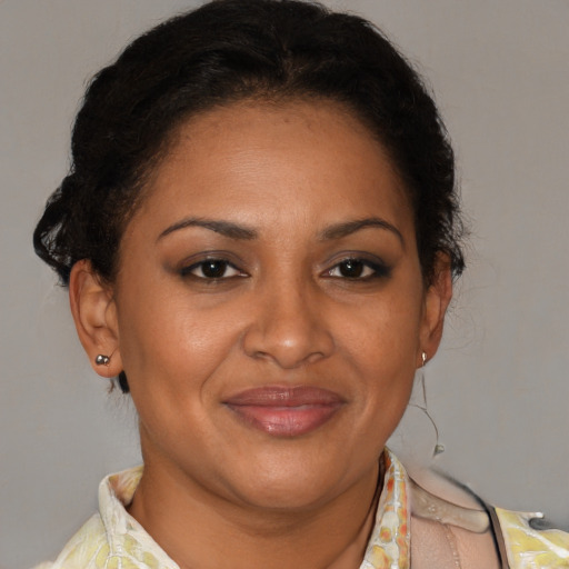Joyful latino adult female with short  brown hair and brown eyes
