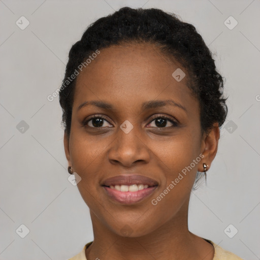 Joyful black young-adult female with short  black hair and brown eyes