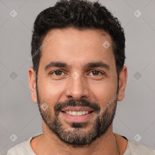 Joyful white young-adult male with short  black hair and brown eyes