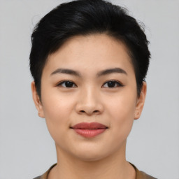 Joyful asian young-adult female with short  black hair and brown eyes