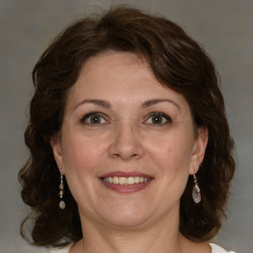 Joyful white adult female with medium  brown hair and green eyes