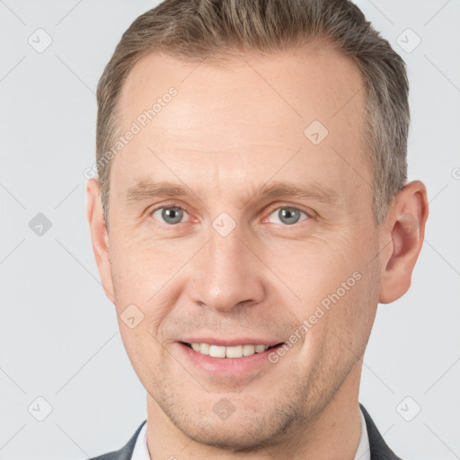 Joyful white adult male with short  brown hair and grey eyes