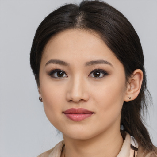 Joyful asian young-adult female with long  brown hair and brown eyes