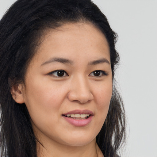 Joyful asian young-adult female with long  brown hair and brown eyes