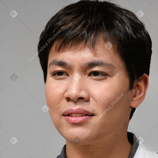 Joyful asian young-adult male with short  brown hair and brown eyes