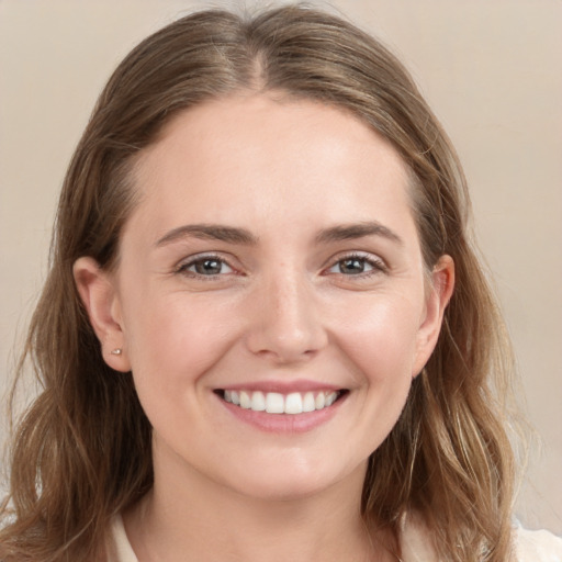 Joyful white young-adult female with medium  brown hair and grey eyes