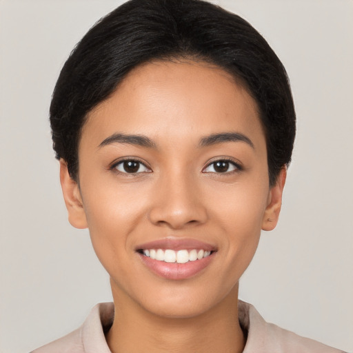 Joyful latino young-adult female with short  black hair and brown eyes